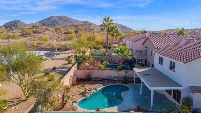 view of swimming pool with a patio and a mountain view