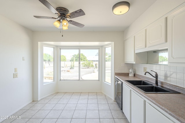 kitchen with a sink, tasteful backsplash, dishwasher, and a wealth of natural light