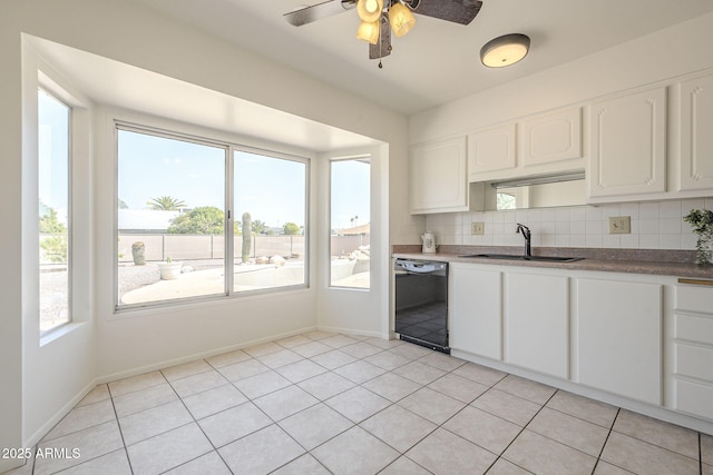 kitchen with a sink, backsplash, dishwasher, and a healthy amount of sunlight