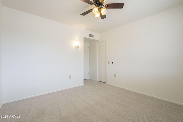 empty room with visible vents, baseboards, light colored carpet, and a ceiling fan