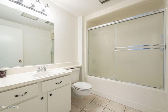 bathroom featuring tile patterned floors, visible vents, toilet, combined bath / shower with glass door, and vanity