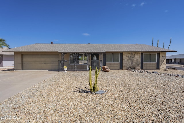 single story home featuring a garage, driveway, and a shingled roof