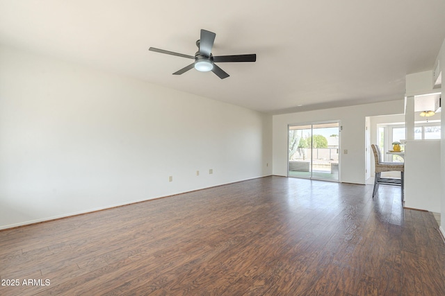 interior space featuring dark wood finished floors, baseboards, and a ceiling fan