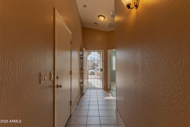 hallway with light tile patterned floors