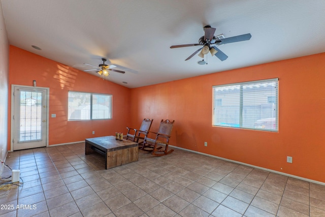 unfurnished room featuring light tile patterned flooring, lofted ceiling, and ceiling fan