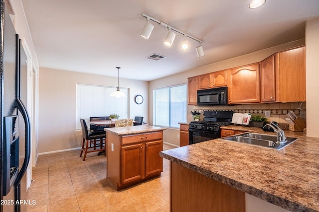 kitchen featuring visible vents, decorative backsplash, light tile patterned flooring, a sink, and black appliances