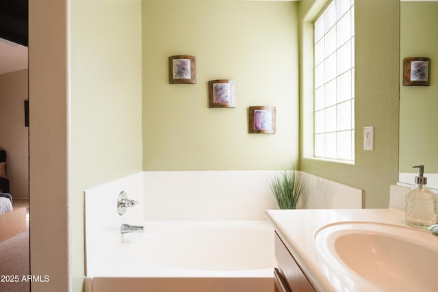 bathroom featuring vanity and a bath