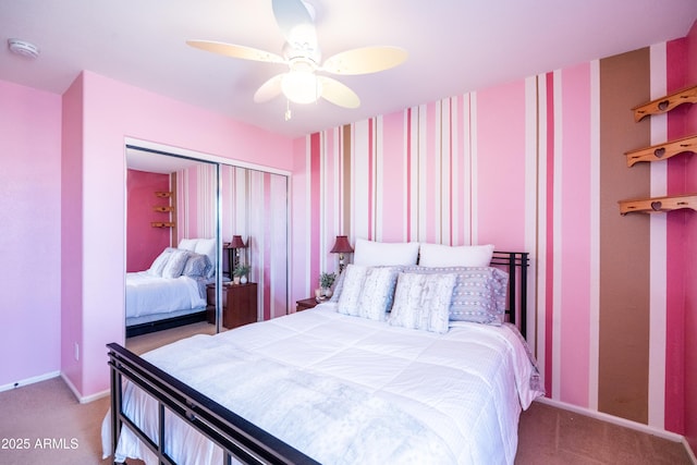 bedroom featuring ceiling fan, carpet floors, baseboards, a closet, and wallpapered walls