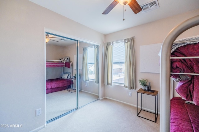 bedroom with a closet, carpet, visible vents, and baseboards