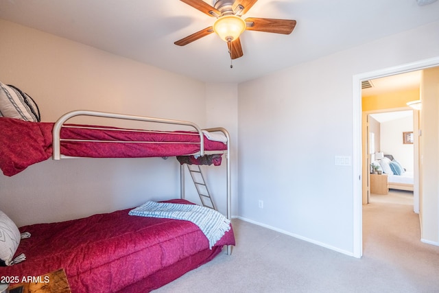 bedroom with carpet, a ceiling fan, and baseboards