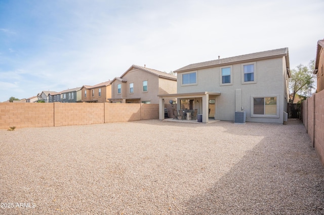 back of property featuring a patio area, a fenced backyard, central AC, and stucco siding