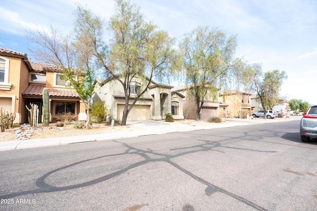 view of front of property with a residential view, a tiled roof, and stucco siding