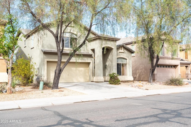 view of front of house featuring a garage, driveway, a tiled roof, and stucco siding