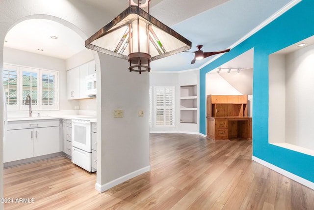 kitchen with ceiling fan, sink, white appliances, built in features, and white cabinets