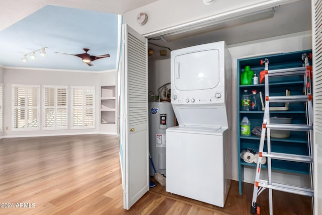 washroom featuring stacked washer and clothes dryer, hardwood / wood-style flooring, electric water heater, ceiling fan, and built in shelves