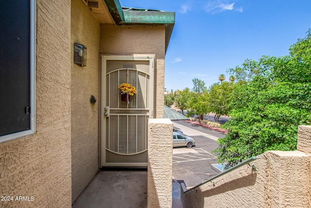 view of exterior entry featuring a balcony