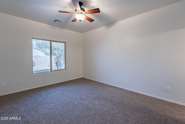 empty room with carpet floors, baseboards, visible vents, and a ceiling fan