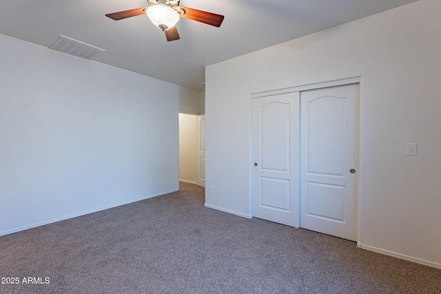 unfurnished bedroom featuring a closet, carpet flooring, visible vents, and baseboards