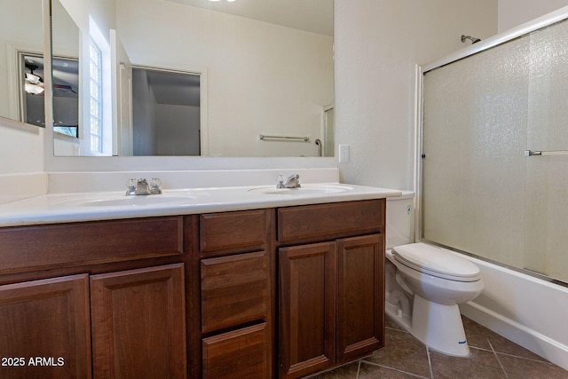 full bathroom featuring double vanity, a sink, toilet, and tile patterned floors