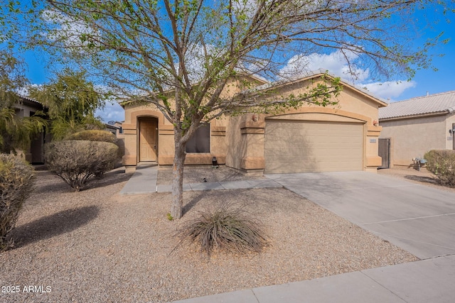 view of front facade with driveway, an attached garage, a tile roof, and stucco siding