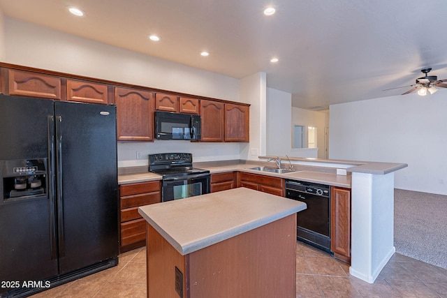 kitchen with a kitchen island, a peninsula, light countertops, black appliances, and a sink