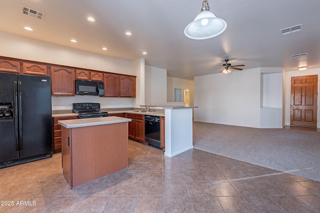 kitchen with light carpet, black appliances, visible vents, and open floor plan