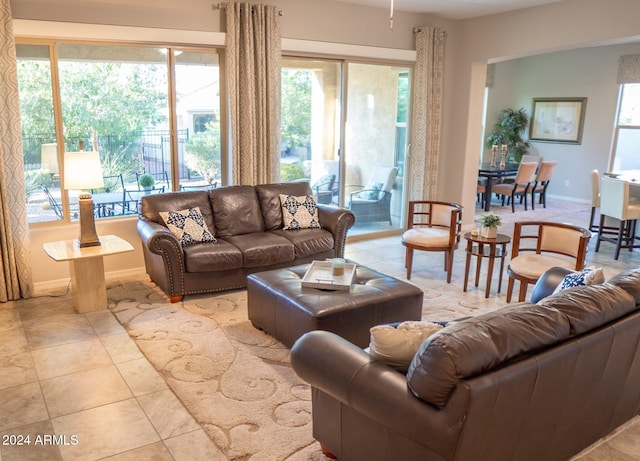 tiled living room with plenty of natural light