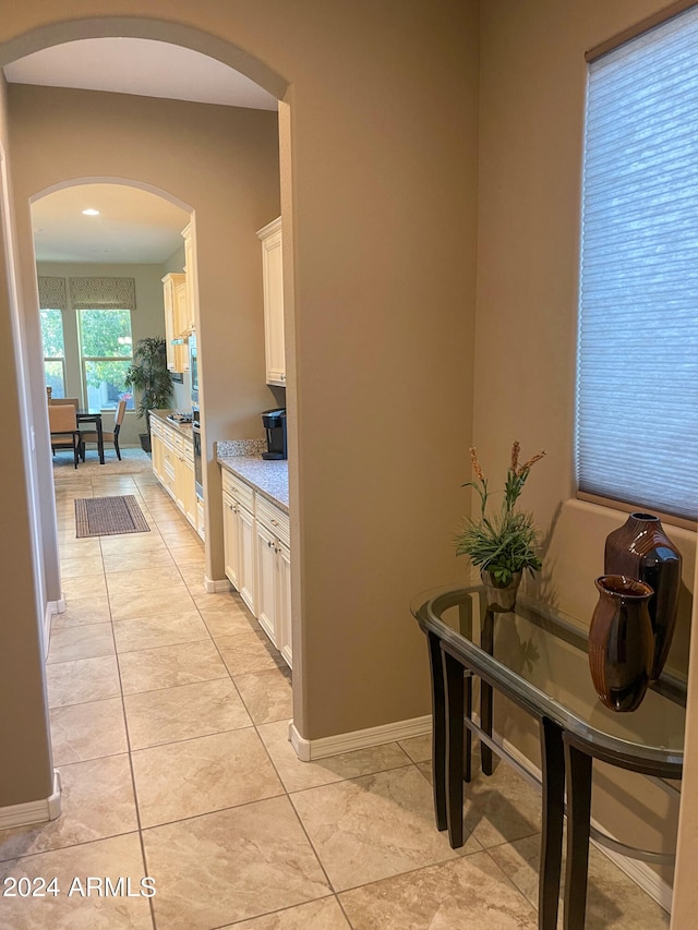 hallway with light tile patterned floors