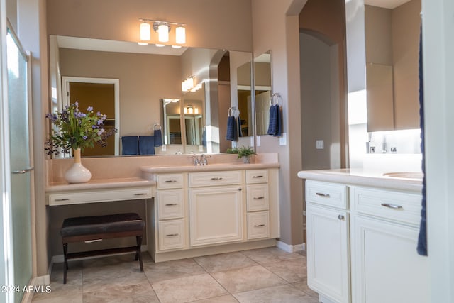 bathroom featuring tile patterned flooring and vanity