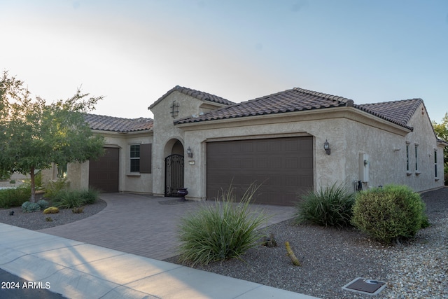 mediterranean / spanish-style house with a garage