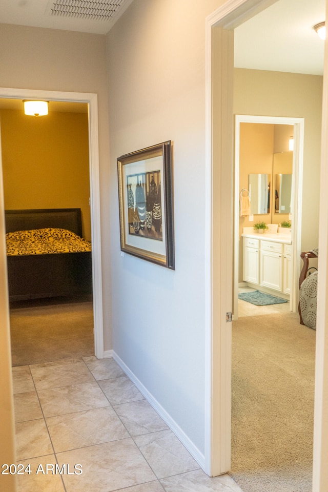 corridor with light colored carpet