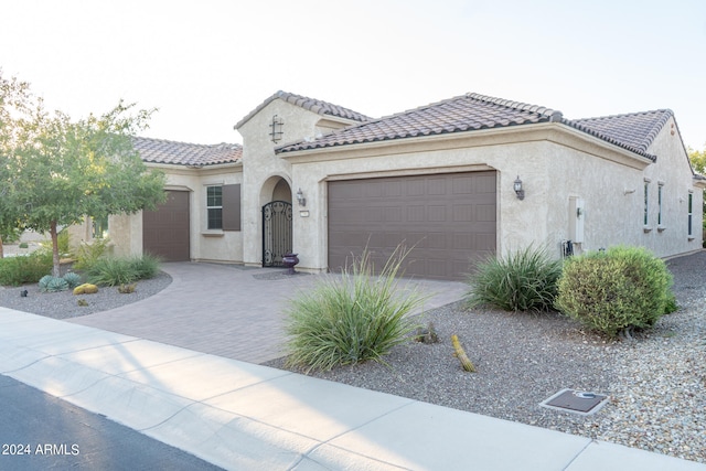 mediterranean / spanish-style home with a garage