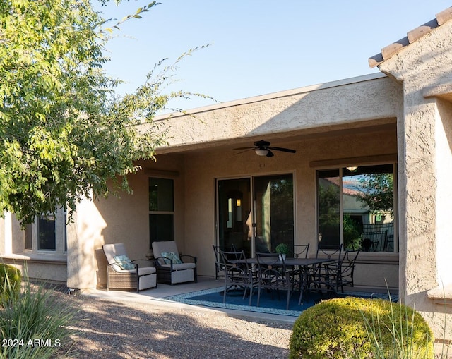27002 W Oraibi Dr, Buckeye, AZ 85396 - back of house with stucco siding, outdoor dining space, ceiling fan, and a patio area