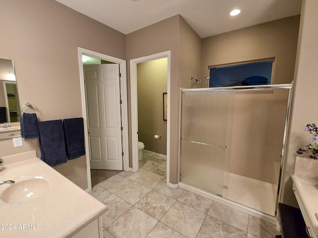 bathroom with tile patterned flooring, vanity, an enclosed shower, and toilet