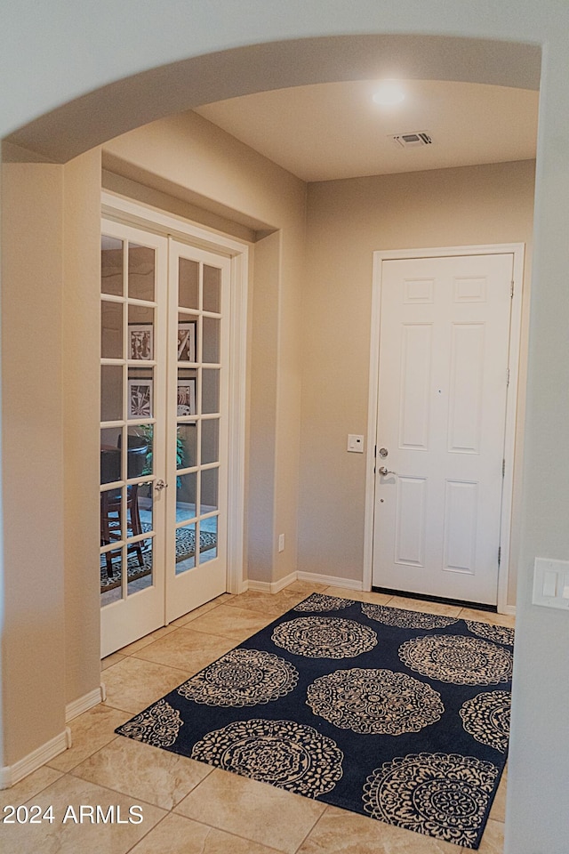 entryway with french doors and tile patterned floors