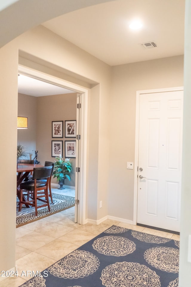 foyer entrance with light tile patterned floors