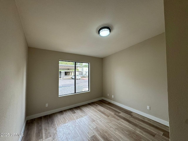 unfurnished room with light hardwood / wood-style floors