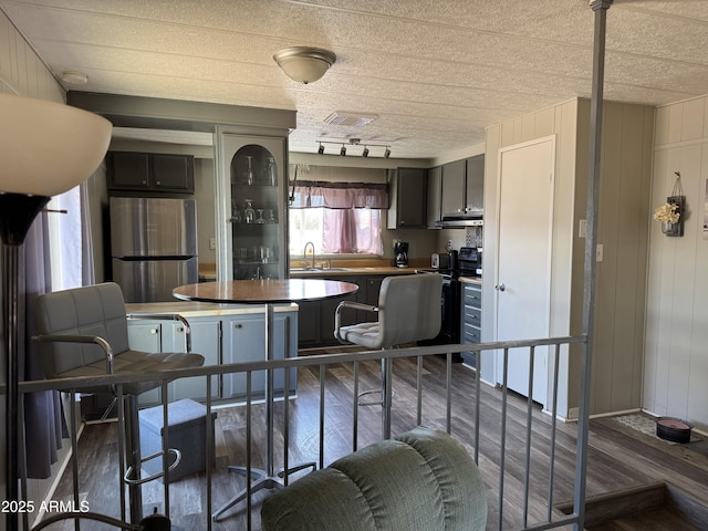 1776 S Lawson Dr, Apache Junction, AZ 85120 - kitchen with freestanding refrigerator, wood finished floors, and rail lighting