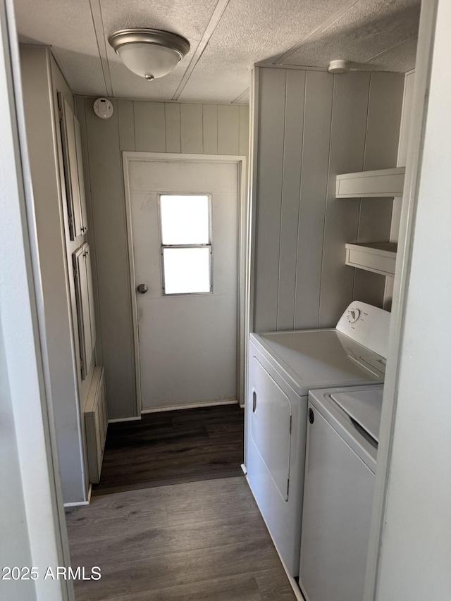 1776 S Lawson Dr, Apache Junction, AZ 85120 - washroom featuring washer and clothes dryer, dark wood-type flooring, a textured ceiling, radiator, and a decorative wall