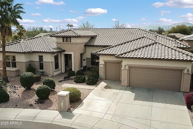 view of front facade with an attached garage, driveway, and stucco siding