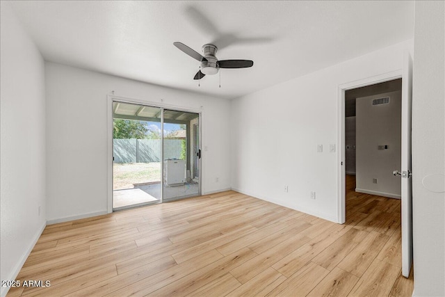 empty room with visible vents, ceiling fan, baseboards, and light wood-style floors