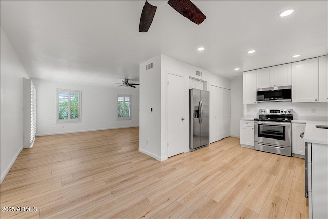 kitchen featuring a ceiling fan, visible vents, light countertops, appliances with stainless steel finishes, and open floor plan