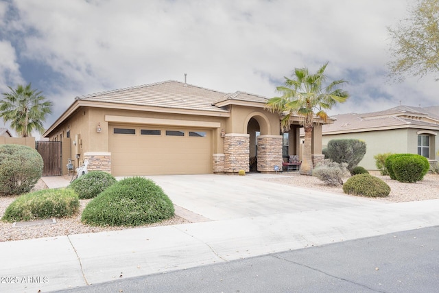 view of front of house with an attached garage, stone siding, driveway, and stucco siding