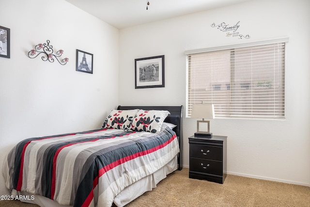 bedroom featuring light carpet and baseboards