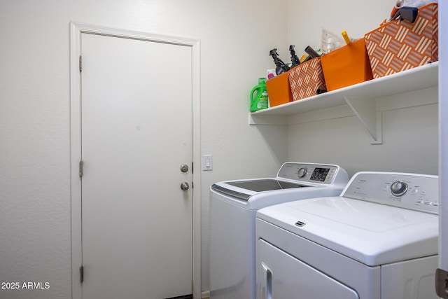 washroom featuring laundry area and washer and clothes dryer