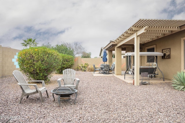 view of yard featuring a fenced backyard, a patio, a fire pit, and a pergola