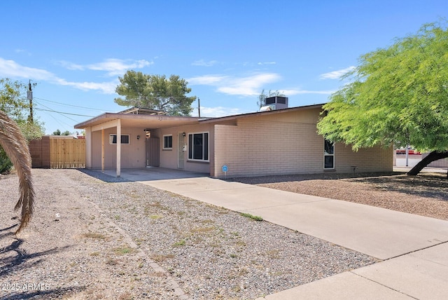 12201 N 22nd Pl, Phoenix, AZ 85022 - single story home with concrete driveway, a carport, and brick siding
