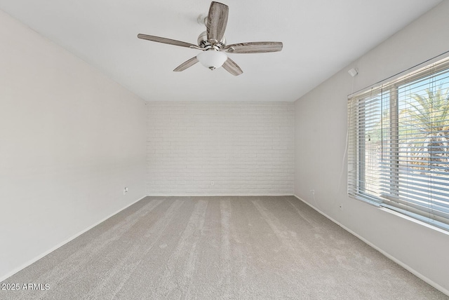 12201 N 22nd Pl, Phoenix, AZ 85022 - carpeted empty room featuring brick wall and ceiling fan