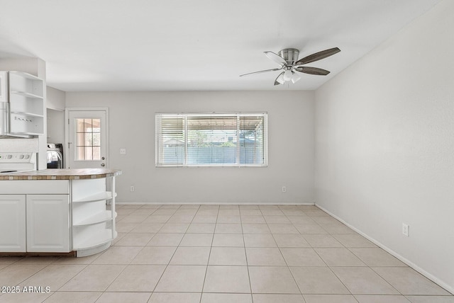 12201 N 22nd Pl, Phoenix, AZ 85022 - kitchen featuring open shelves, ceiling fan, washer / dryer, white cabinets, and white electric stove