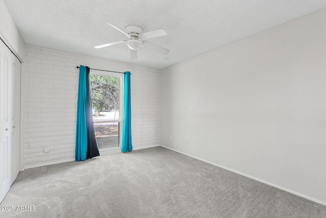 12201 N 22nd Pl, Phoenix, AZ 85022 - empty room featuring ceiling fan, a textured ceiling, carpet floors, and brick wall